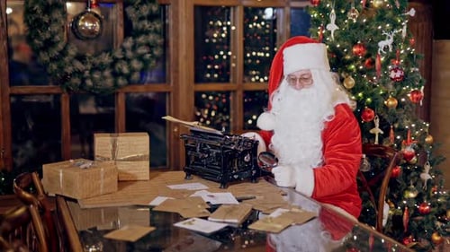 Santa Claus Typing Letters at Festive Christmas Setting