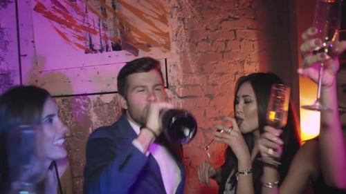 Friends Celebrating with Champagne at Nightclub Party