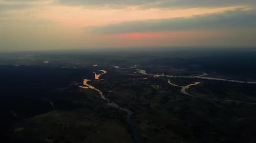 Aerial View of Curved River with Dramatic Sunrise Sky