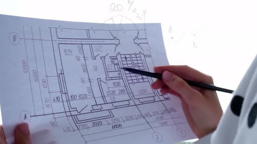 Female Interior Designer Drawing House Plan in Office