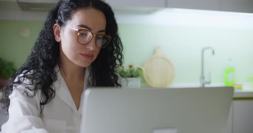 Pretty Young Woman Shopping Online with Credit Card with Laptop While Working on Office at Home