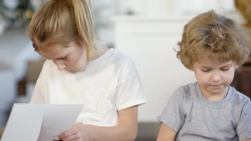 Cute Little Brother and Sister Making Paper Christmas Crafts