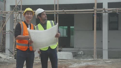 Team group of contractor and architect with foreman explaining about scheme building site.