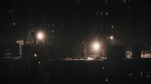 Construction Site Residential Building, Workers Construct at Winter Night in Bad Weather Conditions