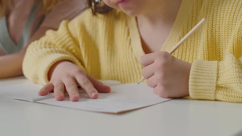 Teen Girl Drawing with Adult Woman Indoors