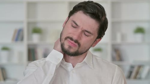 Man Massaging Stiff Neck in Close Up