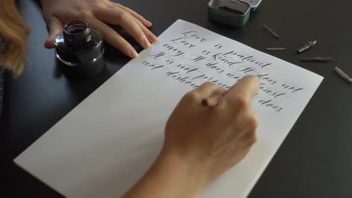 Close Up Shot of a Young Woman Calligraphy Writing on a Paper Using Lettering Technique. She Writes