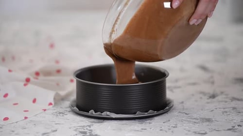 Chocolate Cake Batter Being Poured Into Pan