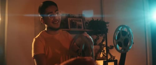 Young Adults Enjoying Vintage Film Projector at Home