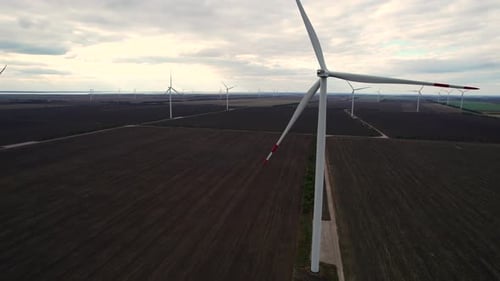 Wind Farm with Generators Produces Energy on Large Field
