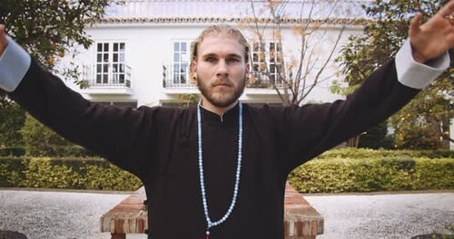 Man in Robe Meditating Outdoors in Serene Garden