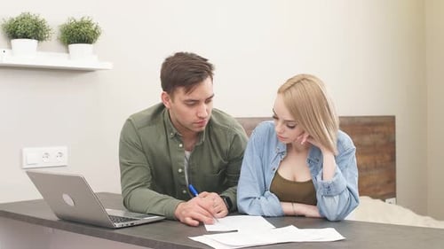 Beautiful Family Studies Bank Loan Documents on Laptop