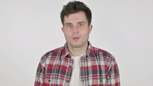 Young Man Talking Directly to Camera Against White