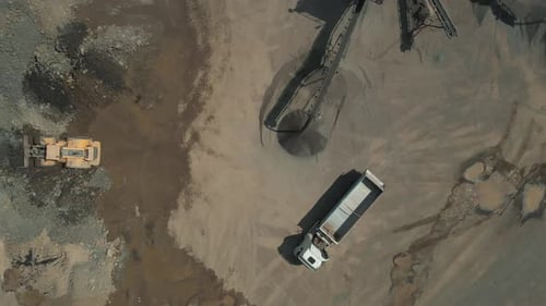 Loader and Truck Working at Industrial Quarry Site