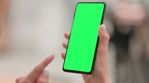 Female Hands Using Smartphone with Green Chroma Key Screen