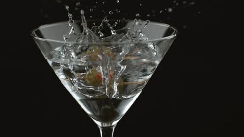 Olive Drops into Martini Cocktail Glass in Studio