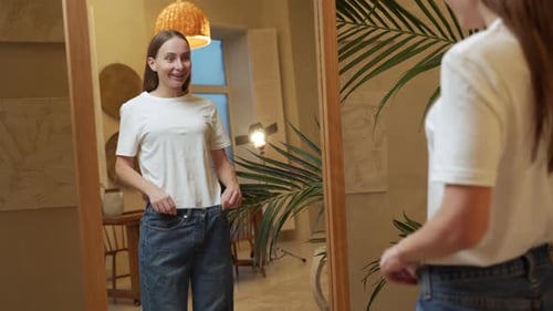 Woman Excited by Weight Loss, Oversized Jeans