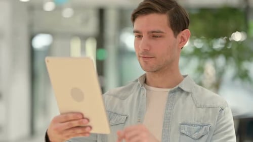 Portrait of Creative Young Man Using Digital Tablet