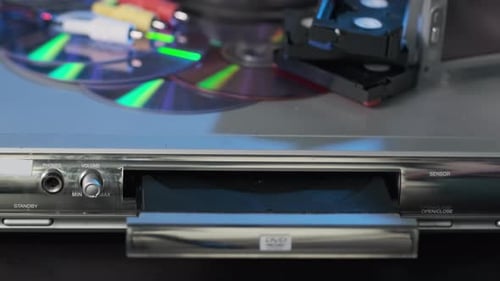 Closeup of Man Inserting Disc to DVD Player