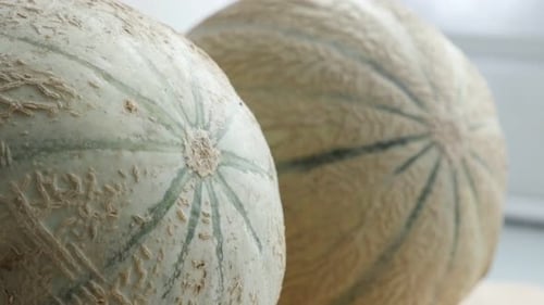 Paire de fruits melopepo de la famille des cucurbitacées juteuses sur une table de cuisine 4K 2160p 30fps, pieds inclinables UltraHD