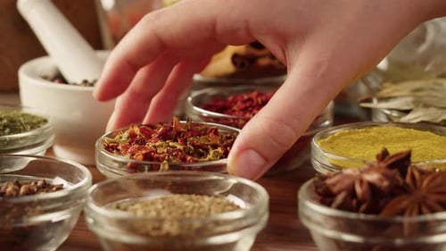 Colorful Spices and Hand Selecting Seasonings
