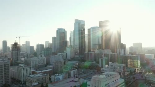 AERIAL: Flying Towards Downtown Los Angeles, California Skyline with Look at Houses and Street