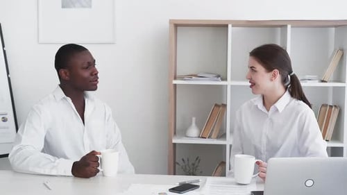 Colleagues Discuss Business in Modern Office Setting