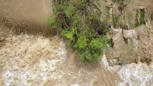 Aerial view of wide dirty river with muddy water in flooding period during heavy rains in spring.