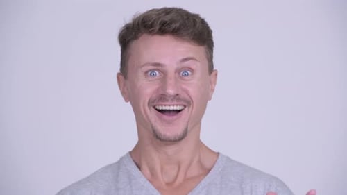 Man Reacts with Surprise and Happiness Close Up