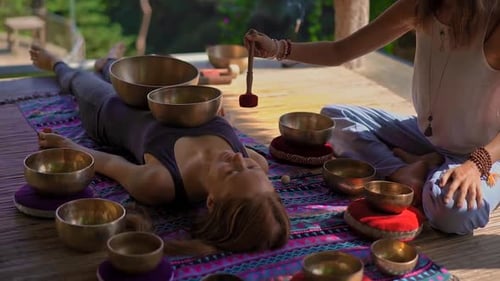 Women Meditating with Singing Bowls in Nature