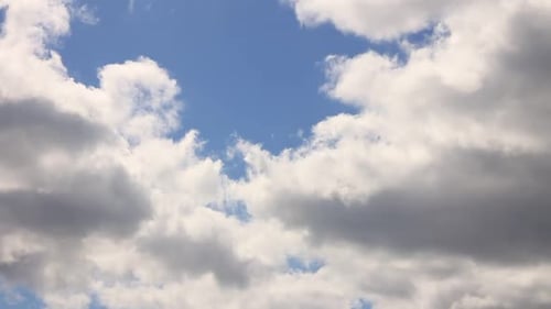 Drifting Clouds in a Bright Blue Sky