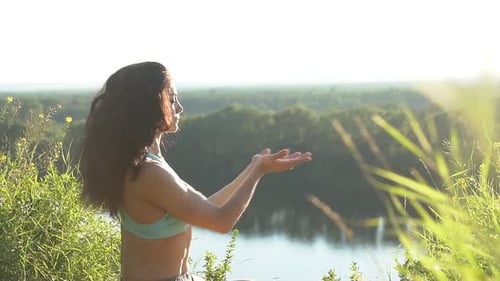 Woman Practicing Yoga at Sunrise in the Countryside