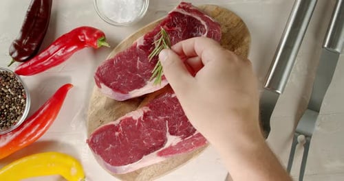 Steaks Raw Beef Ribeye on a Wooden Cutting Board.