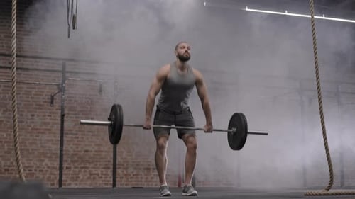 Man Lifting Barbell During Intense Gym Workout