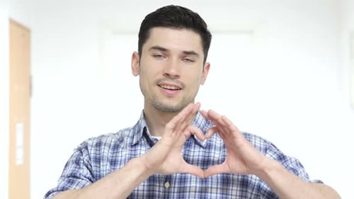 Man Makes Heart Symbol With Hands Close Up