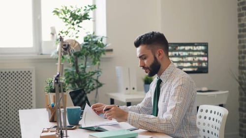 Stressed Guy Reading Business Contract Shaking Head Throwing Pen in Office