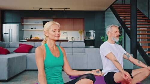 Mature Couple Meditating at Home