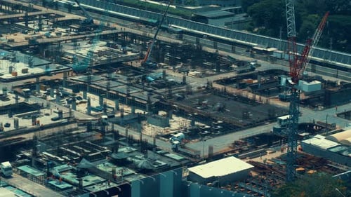 Large Construction Site with Heavy Construction Machinery in Metropolis