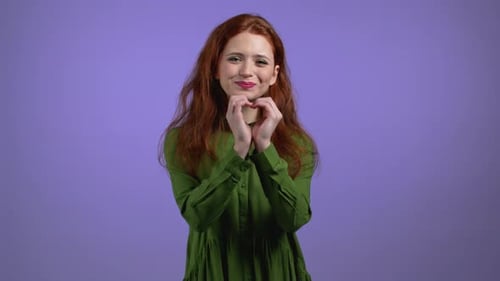 Happy Woman Making Heart Shape with Hands