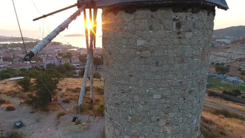 Old Traditional Historic Stone Windmill by the Sea at the Sunset