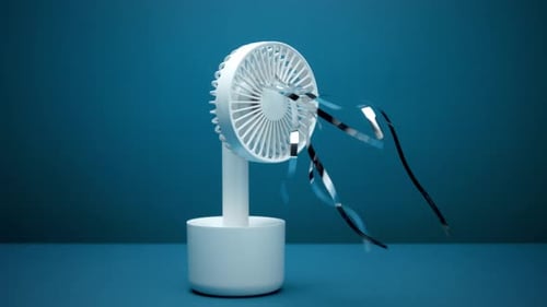 Portable Fan with Streamers on Blue Background