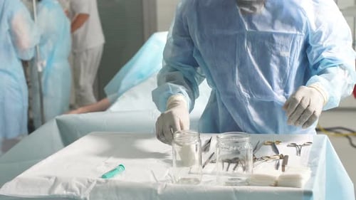 Medical Staff Preparing Tools and Dressings in Operating Room