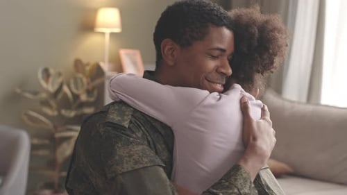 Soldier Hugs Daughter in Living Room