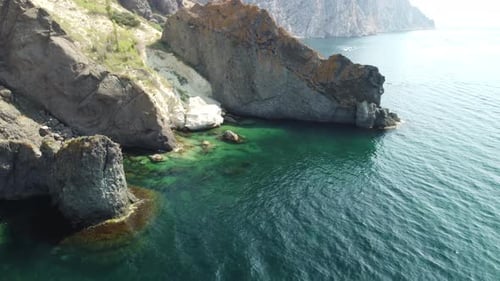 Aerial View From Above on Calm Azure Sea and Volcanic Rocky Shores