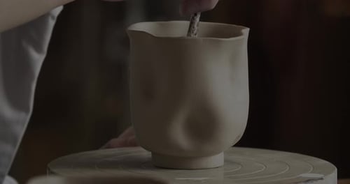Potter Shapes Clay on Rotating Pottery Wheel