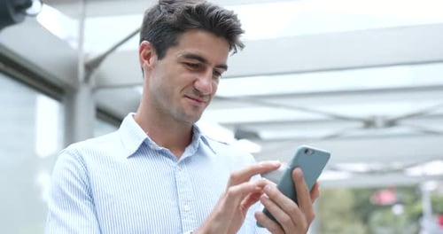 Businessman use of cellphone in Hong Kong city
