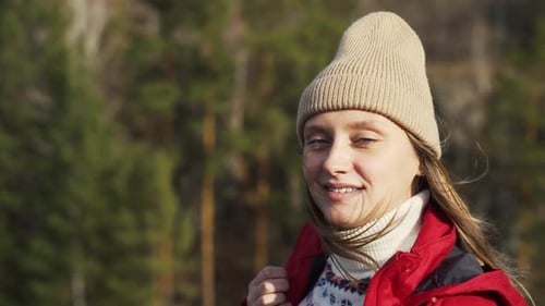 Young Woman Smiles Outdoors Wearing Red Jacket