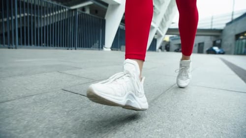 Close Up Female Legs Running on Urban Street. Woman Legs Jogging Outdoor.