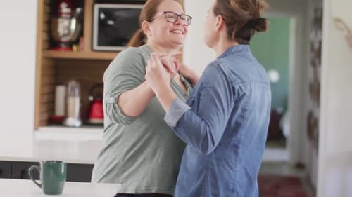 Two Women Dancing and Smiling in Kitchen