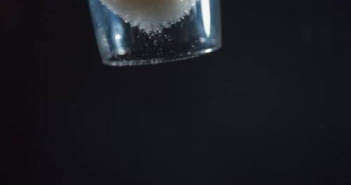 Close Up of Falling Sugar on Glass Table, View From Under,